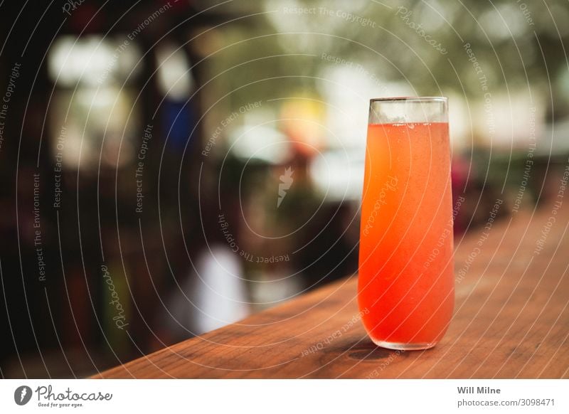 Colorful Cocktail on a Table at a Restaurant Beverage Drinking Alcoholic drinks Red Orange Colour Multicoloured Bar Counter Pub Mixed drink Glass