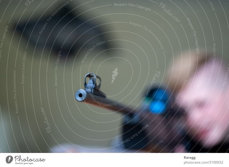 a young man looks and aims through the rifle scope Lifestyle Summer Sports Human being Masculine Child Boy (child) Head 1 8 - 13 years Infancy Nature Cold