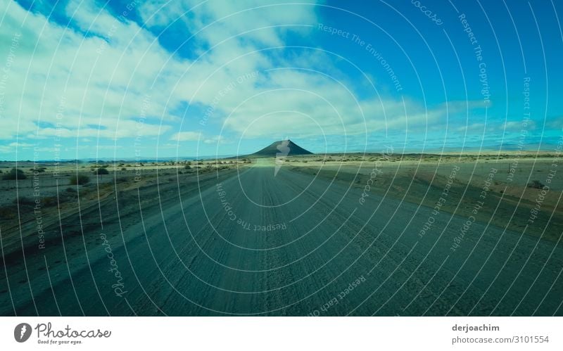 My destination on the lonely sand road is the mountain in the background. Blue sky and clouds. Vacation & Travel Nature Summer Beautiful weather Mountain