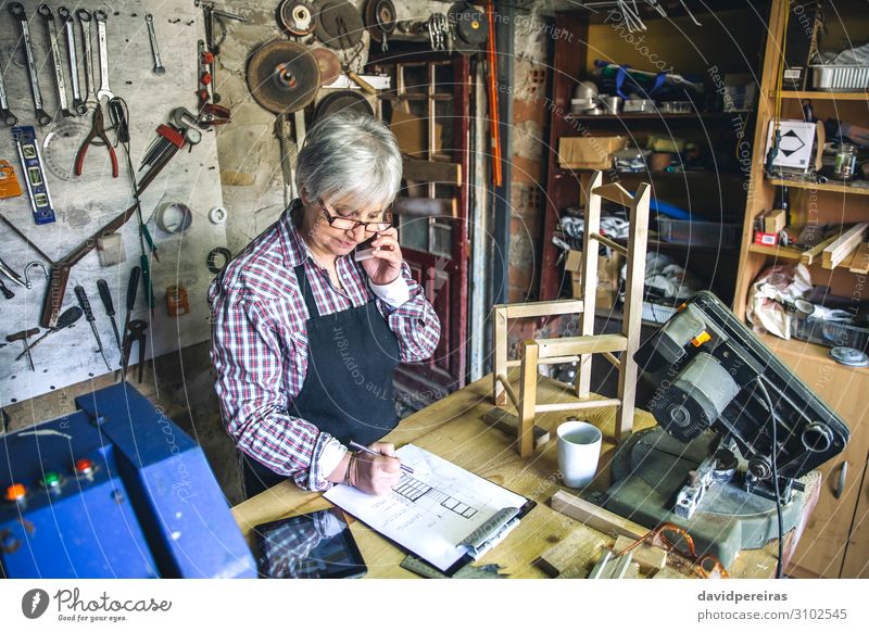 Female carpenter in her workshop Chair Craft (trade) Business To talk Human being Woman Adults Aircraft Wood Old Authentic carpentry Carpenter mobile senior