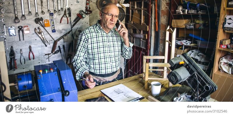 Carpenter in his workshop Chair Craft (trade) Business To talk Internet Human being Man Adults Wood Old Authentic carpentry mobile senior Custom-made Workbench