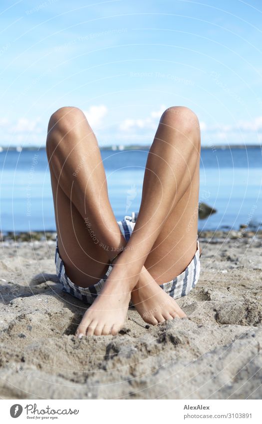 1500 Young woman lying on the beach with her legs crossed. Style already Athletic Fitness Wellness Summer Summer vacation Sunbathing Beach Ocean