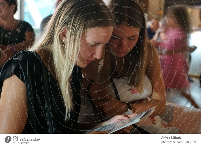 Two teenage girls looking at the menu in a restaurant Feminine Young woman Youth (Young adults) Friendship 2 Human being 13 - 18 years Fishing village Old town