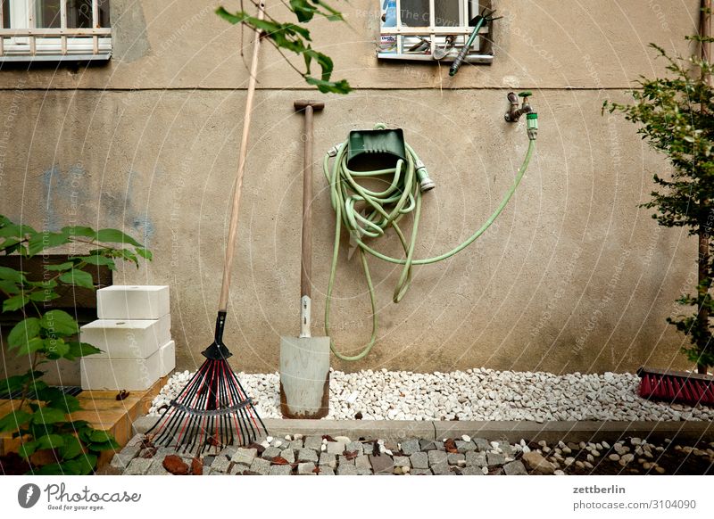 Garden in the backyard Gardening equipment Hose Garden hose Water Tap Water hose Spade Shovel Living or residing Apartment Building Facade Window Grating Gravel