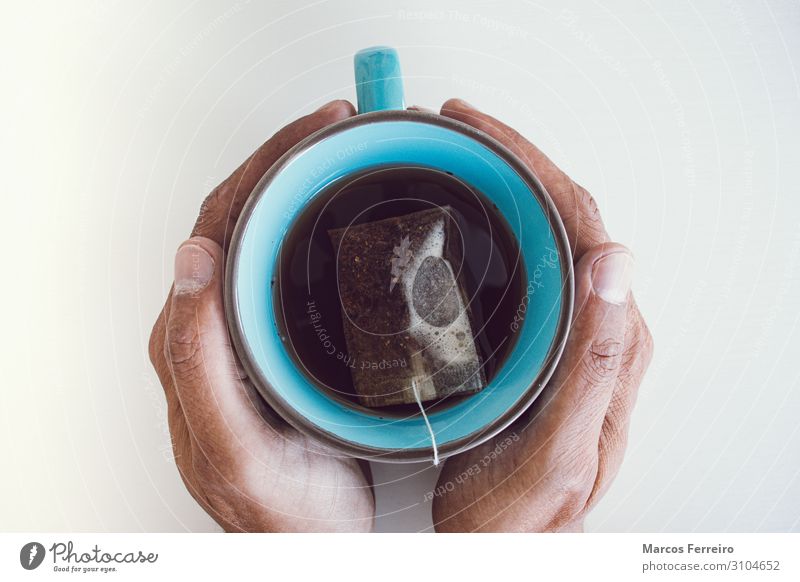 tea cup between hands with white background Beverage Drinking Hot drink Tea Lifestyle Healthy Eating Relaxation Living or residing Desk Human being Masculine