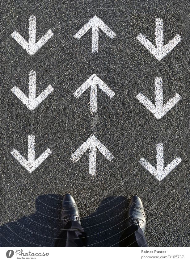 A man looks down on three rows of arrows, one row of which points forward and the other two point against him. Work and employment Financial institution