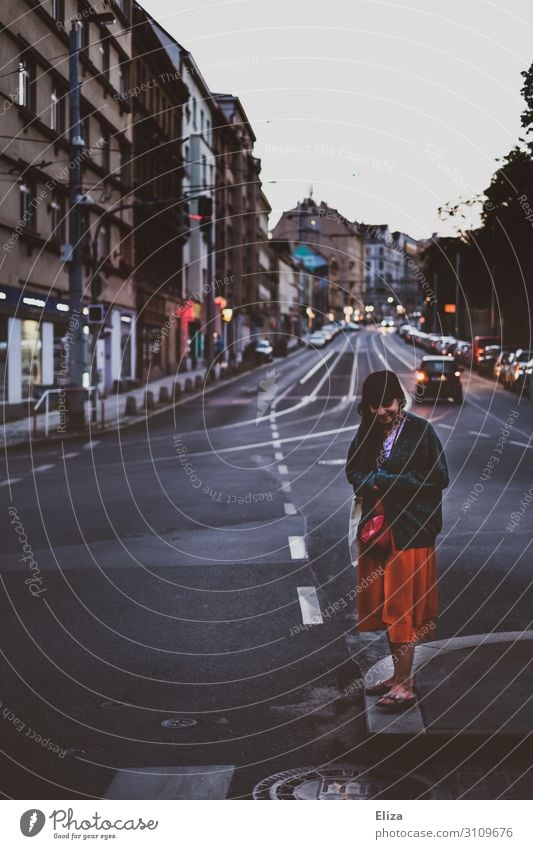 Woman standing on a crossroads Feminine Young woman Youth (Young adults) Adults 1 Human being 18 - 30 years Town Transport Road traffic Pedestrian Street