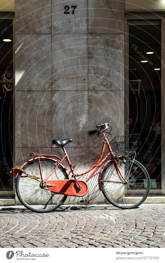 Red bike with basket on italian street. Lifestyle Style Relaxation Vacation & Travel Tourism Summer Sun Sports Cycling Town Transport Street Metal Old Retro