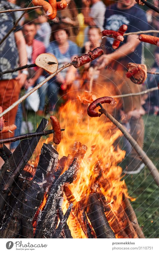 People roasting sausages and bread over a campfire Food Sausage Bread Fast food Vacation & Travel Authentic Hot people Bonfire fireplace barbecue burn grill