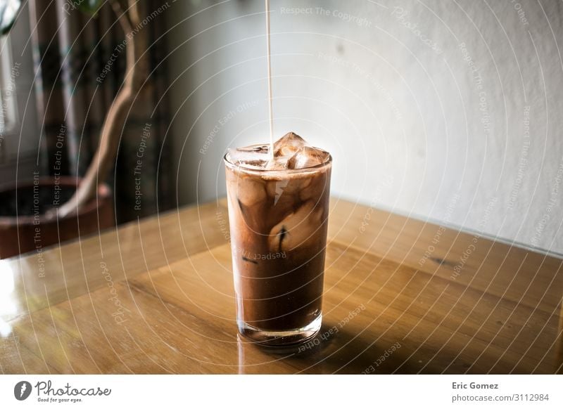 Pouring milk into chocolate espresso iced coffee Chocolate To have a coffee Beverage Cold drink Milk Coffee Latte macchiato Espresso Glass Lifestyle Elegant Joy