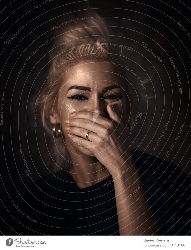 Tousled blonde laughing with her hand covering her mouth Style Beautiful Skin Face Woman Adults Mouth Hand 30 - 45 years Actor Ring Blonde Smiling Laughter