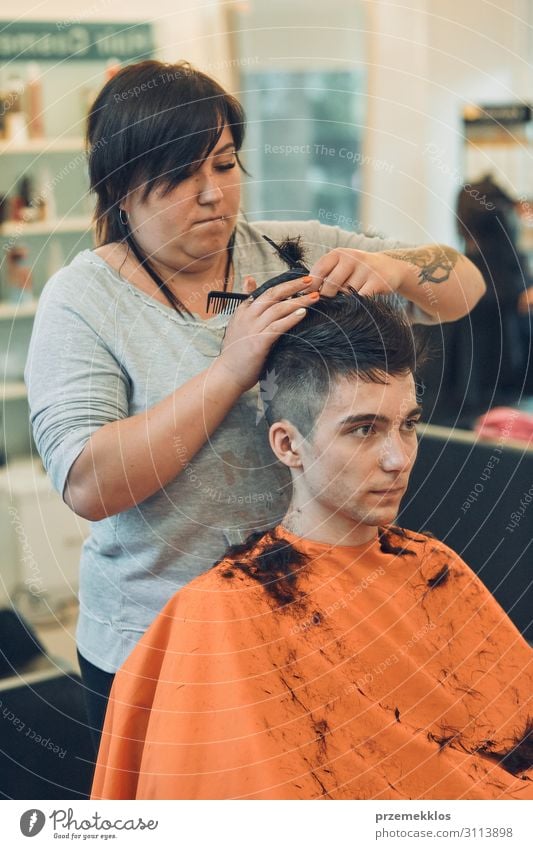 Hairdresser is haircutting styling young mans hair Lifestyle Shopping Style Hair and hairstyles Work and employment Profession Scissors Woman Adults Man 2