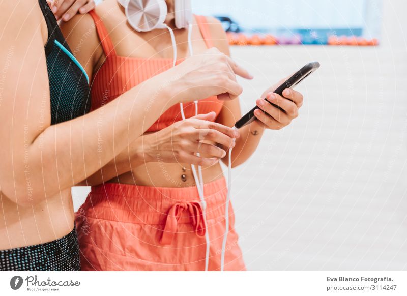 two friends women at the gym talking happily, listening to music Lifestyle Joy Happy Beautiful Wellness Relaxation Leisure and hobbies Music Sports Sportsperson