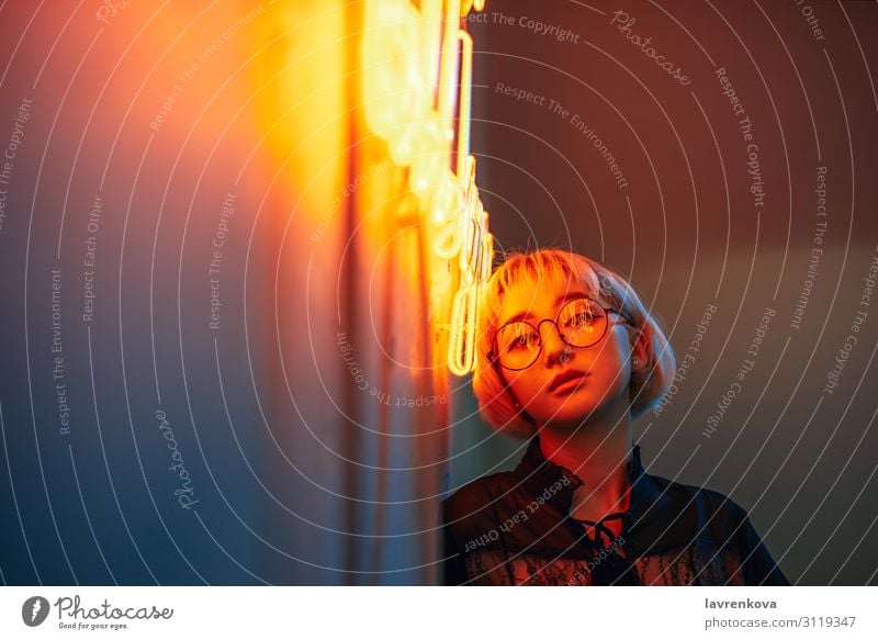 Young adult asian female wearing glasses in front of neon light sign, shallow selective focus Asians Blonde Eyeglasses Woman Young woman Girl Lighting