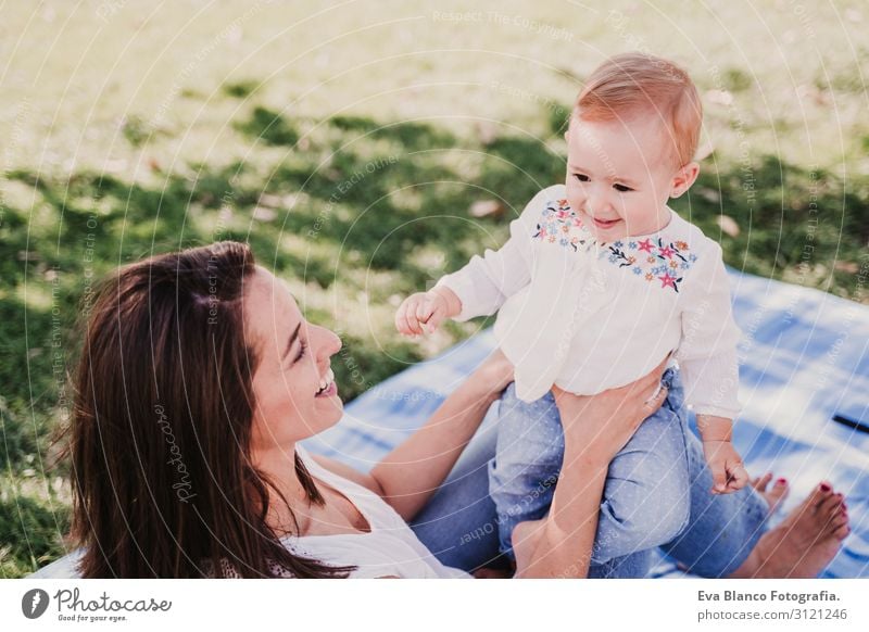 young mother playing with baby girl outdoors in a park Lifestyle Joy Happy Beautiful Playing Summer Sun Parenting Child Human being Feminine Baby Young woman