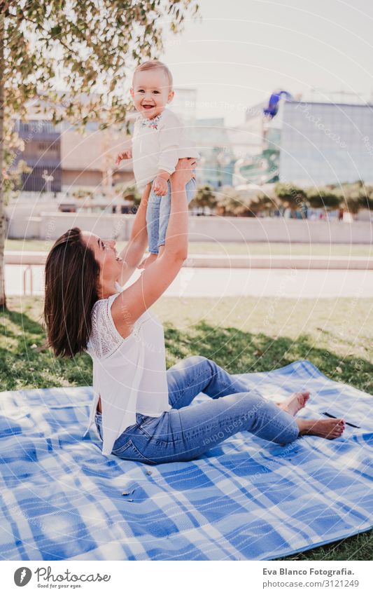 young mother playing with baby girl outdoors in a park Lifestyle Joy Beautiful Playing Summer Sun Parenting Child Feminine Baby Young woman Youth (Young adults)