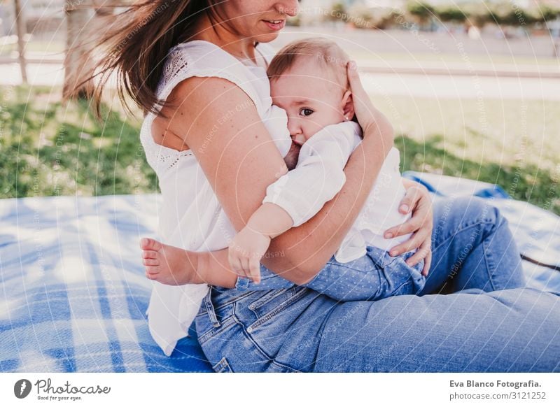 young mother breast feeding her baby girl outdoors in a park Eating Lifestyle Joy Happy Beautiful Playing Summer Sun Parenting Child Feminine Baby Young woman