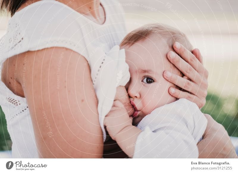 young mother breast feeding her baby girl outdoors in a park Eating Lifestyle Joy Beautiful Summer Sun Parenting Child Feminine Baby Young woman