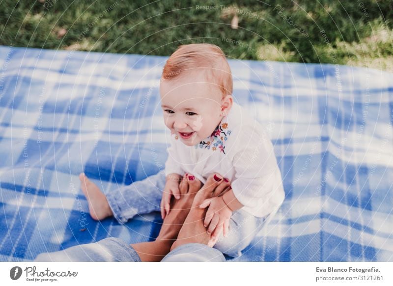 young mother playing with baby girl outdoors in a park Lifestyle Joy Happy Beautiful Playing Summer Sun Parenting Child Technology Feminine Baby Young woman