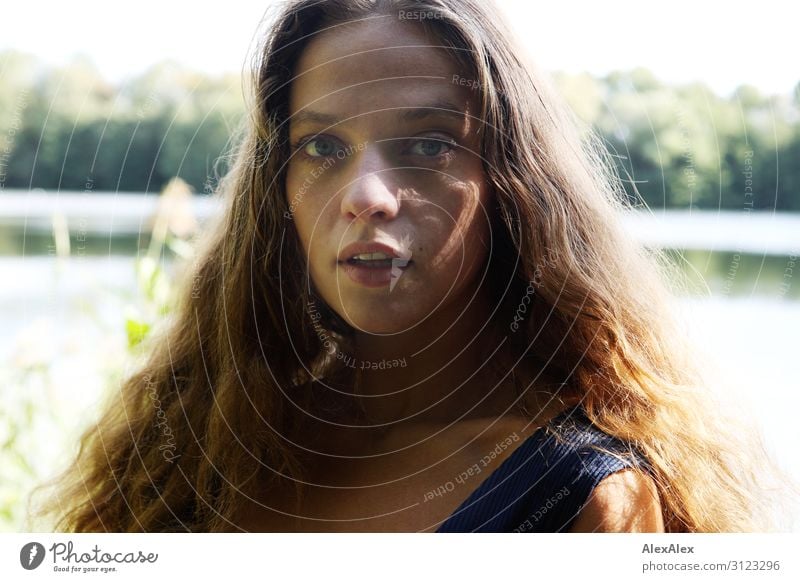 Portrait of a young woman with long, brunette hair at a lake in summer Style already Wellness Life Trip Young woman Youth (Young adults) 18 - 30 years Adults