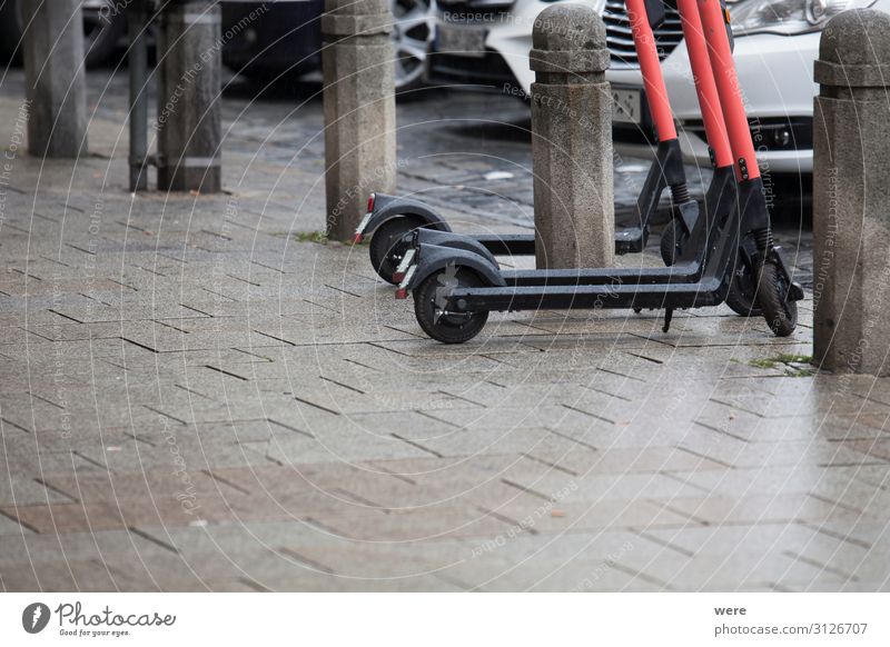 Electric scooters are on the road in the rain Cycling Transport Means of transport Traffic infrastructure Passenger traffic Modern Augsburg battery