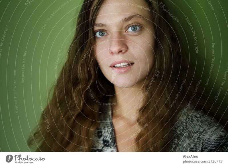 Portrait of a young woman in front of a green wall Style Joy already Wellness Life Young woman Youth (Young adults) 18 - 30 years Adults brunette Long-haired