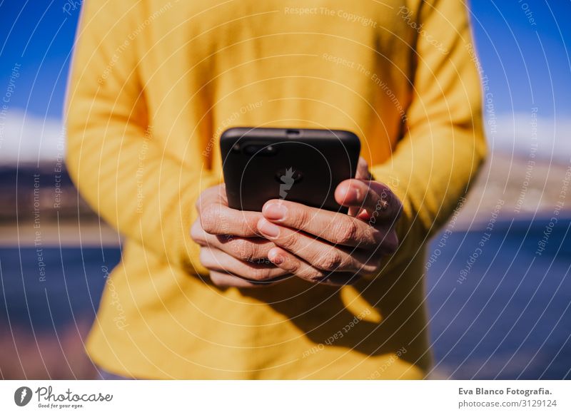 caucasian woman on the mountain using mobile phone.sunny day Lifestyle Joy Beautiful Calm Leisure and hobbies Vacation & Travel Winter Mountain Cellphone PDA