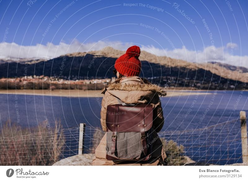 young caucasian woman on the mountain in sunny day. Beautiful lake background view. Nature concept. back view Surface Hat tour tourism Lovely Calm Mountain Day