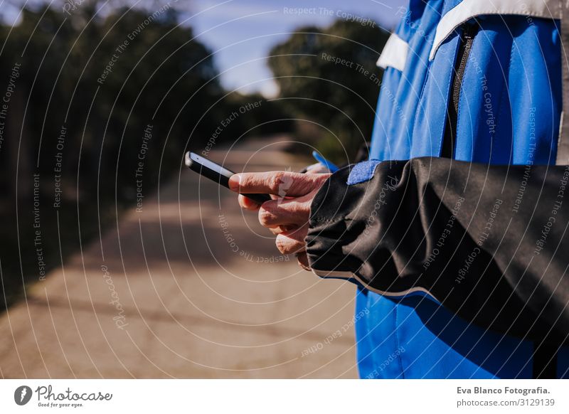 caucasian man using mobile phone outdoors in nature. sunny day Nature Adventure American discovering backpacker traveler Green To enjoy westerner hiker