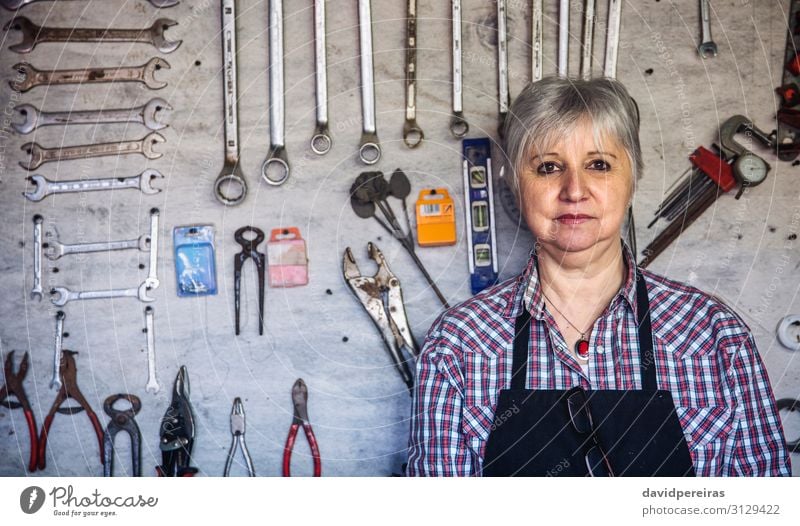 Female carpenter posing with crossed arms in his workshop Craft (trade) Business Human being Woman Adults Old Authentic Carpenter Mature tool board Organized