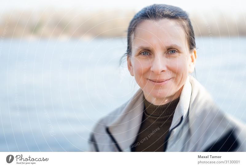 Woman's Portrait Close to the River Lifestyle Happy Beautiful Face Beach Winter Human being Adults Nature Coast Smiling Illuminate Cool (slang) Thin Happiness