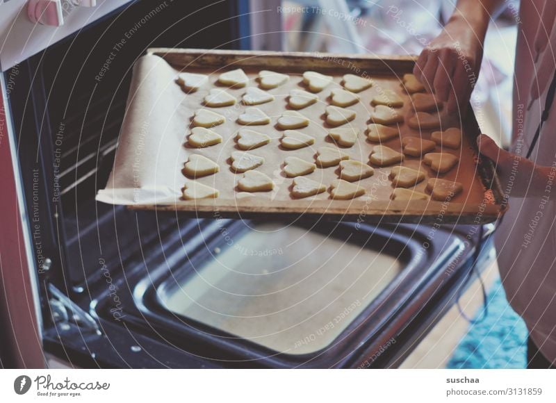 Off to the oven Cookie Christmas biscuit Baked goods Baking Stove & Oven Baking tray Sweet Candy Christmas & Advent Hot push in Kitchen Cooking Human being Hand