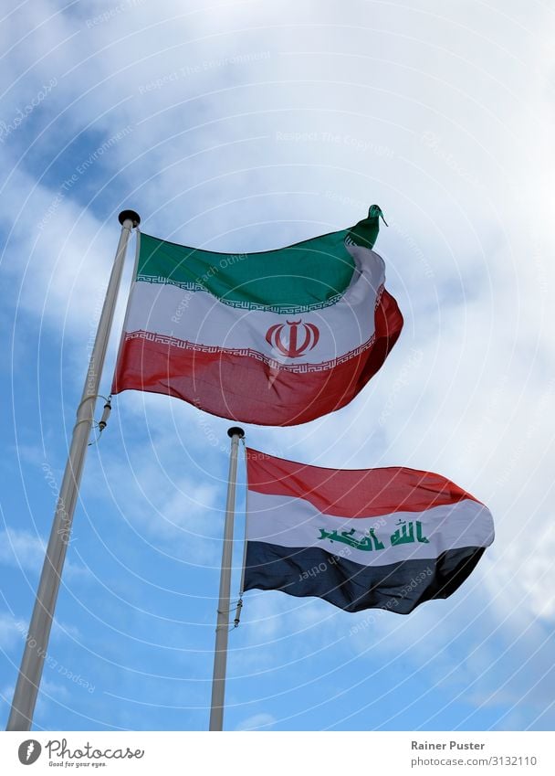 The national flags of Iran and Iraq against a blue sky Tehran Near and Middle East Landmark Flag Ensign Blue Green Black White Attachment Colour photo