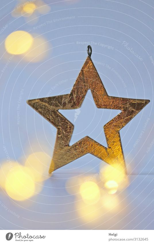 golden star as decoration in front of a light blue background with shining bokeh Christmas & Advent Decoration Sign Star (Symbol) Glittering Illuminate Esthetic