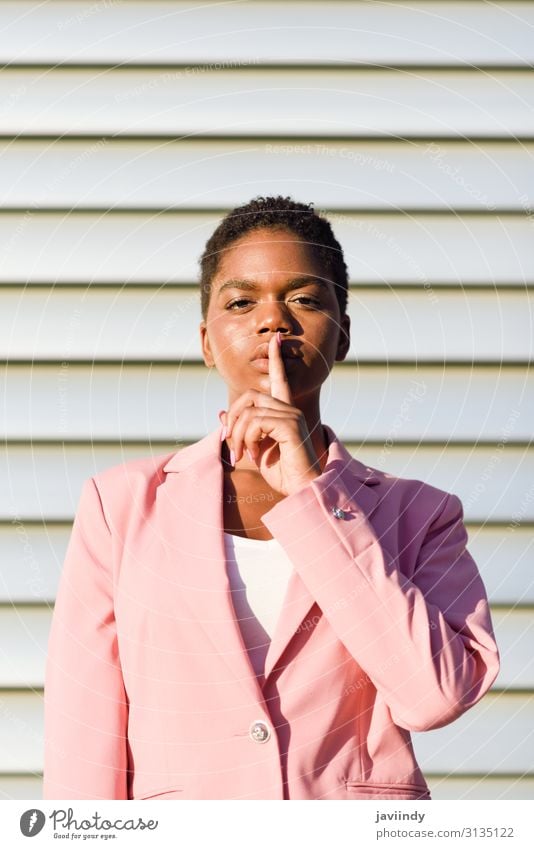 African American business woman doing silence gesture. Hair and hairstyles Face Calm Work and employment Business Human being Feminine Young woman