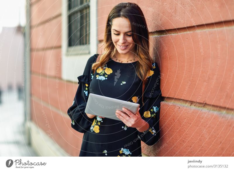 Smiling young woman using digital tablet outdoors. Lifestyle Style Happy Beautiful Hair and hairstyles Face Leisure and hobbies Vacation & Travel Computer