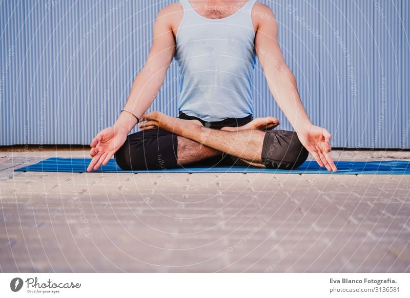 man in the city practicing yoga sport. blue background. healthy lifestyle Yoga Man Sports Healthy Exterior shot City Blue background Muscular