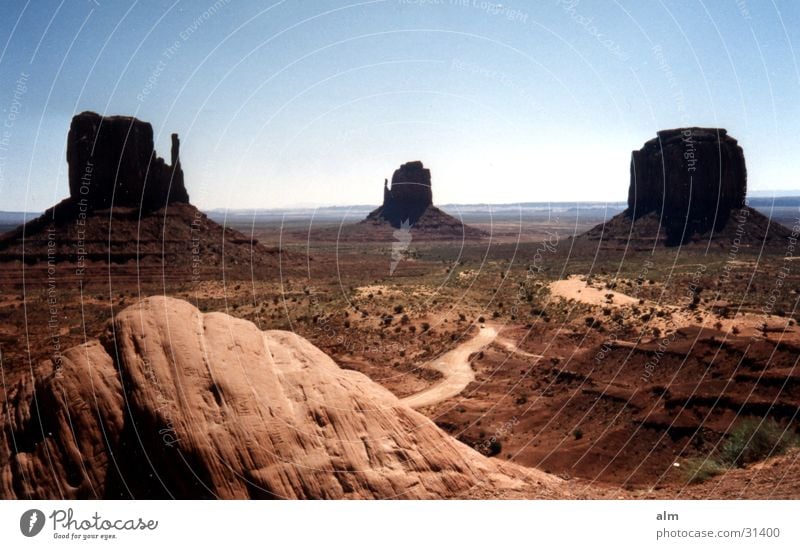 the rock Blue sky Desert Rock Rock formation Monument Valley Famousness Attraction Tourist Attraction Clear sky Cloudless sky Around-the-world trip Destination