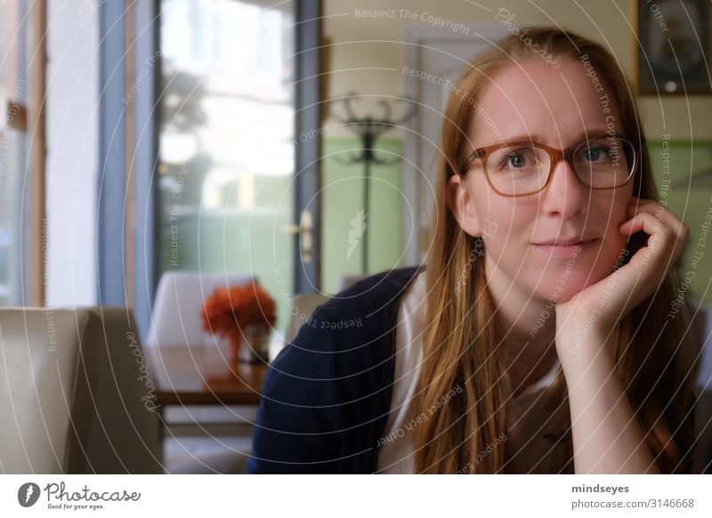 Young woman in a café Feminine Youth (Young adults) 1 Human being 18 - 30 years Adults Town Café Eyeglasses Red-haired Long-haired Hallstand Relaxation Smiling