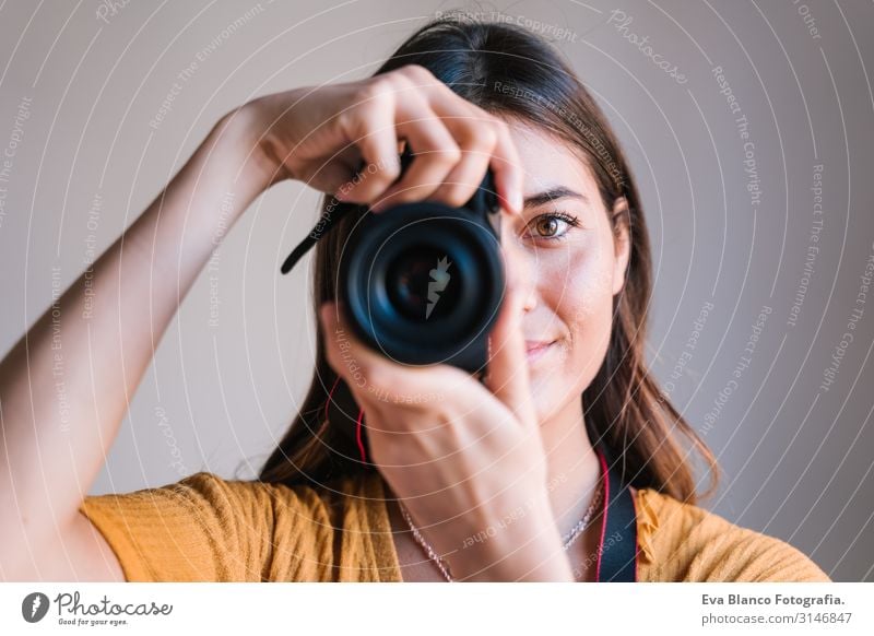 photographer woman at home holding a camera. Technology and lifestyle indoors Caucasian Woman Youth (Young adults) Photographer Camera reflex Home Lifestyle