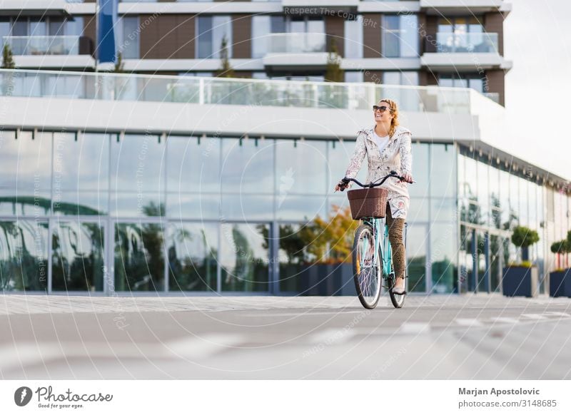 Young happy woman riding a bicycle in the city Lifestyle Joy Leisure and hobbies Cycling Bicycle Feminine Young woman Youth (Young adults) Woman Adults 1