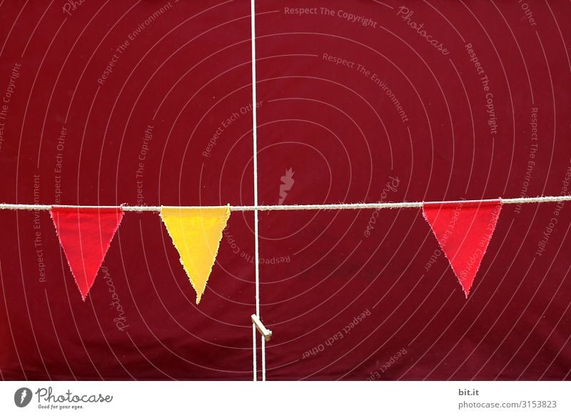 Tensioned rope, cord as a cross, in front of a tarpaulin made of fabric from a tent, at an event with flags, pennants in red and yellow, against a background in wine red, Bordeaux.