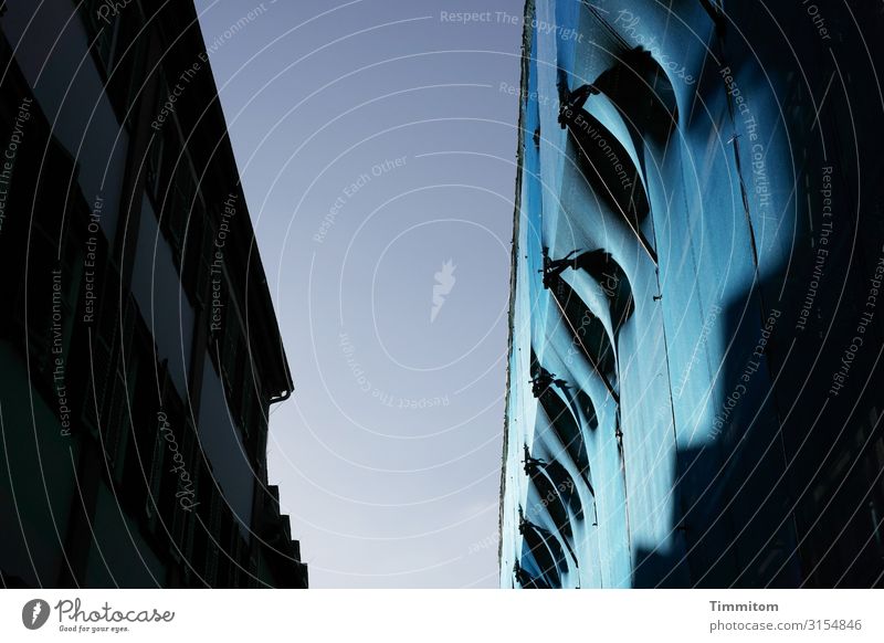 Blue building site and dark opposite House (Residential Structure) houses Construction site shrouded Light Shadow Contrast Sky lines curves Facade Roof Building