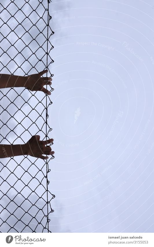 man grabbing a metallic fence Hand Fence Wire Safety (feeling of) Metal Protection Man Human being Fingers body part Arm Steel Street Exterior shot Freedom