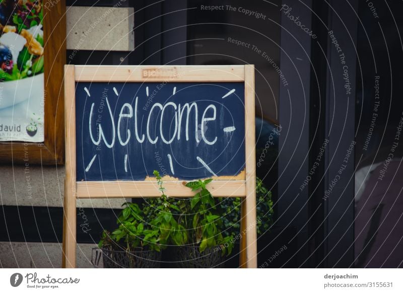 "Welcome" is on a sign by the road. Nutrition Shopping Joy Contentment Leisure and hobbies Trip Restaurant Feasts & Celebrations Services Autumn