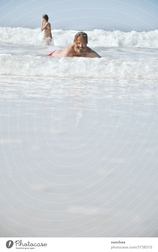 bathers Man Child Ocean Water Beach fun be afloat Waves Fresh Bubbling Wet Summer Swimming & Bathing Vacation & Travel Relaxation Joy Tourism Sun