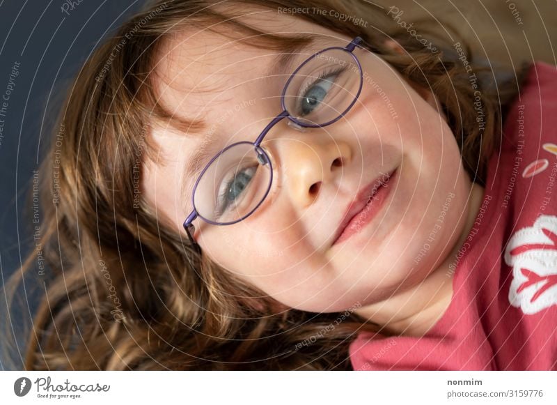 Young blue eyed girl with eye glasses looking into the light Beautiful Child Baby Infancy Eyes Eyeglasses Blonde Think Small Cute Blue Concentrate Innocent