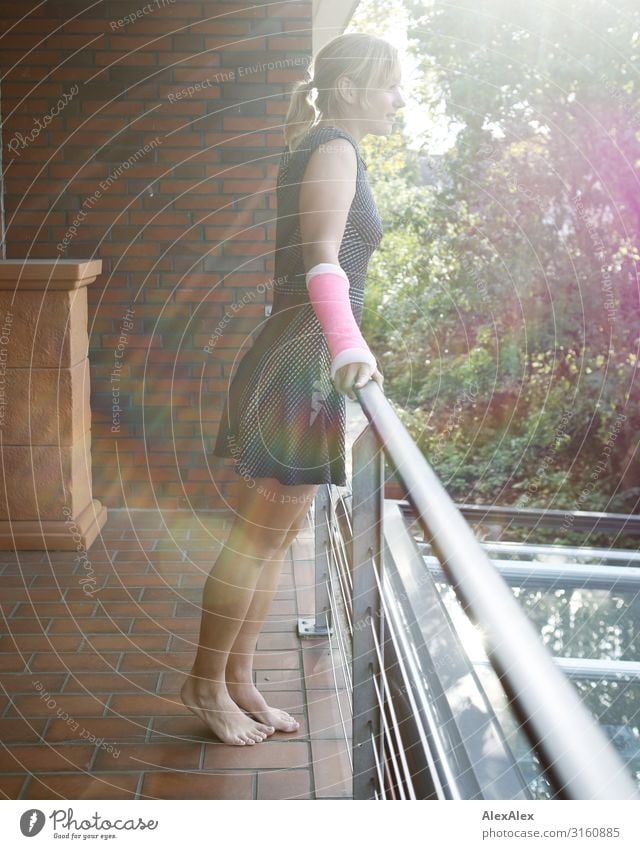 Young woman with plaster arm standing on a balcony railing Style Beautiful Life Balcony Handrail Brick wall Youth (Young adults) 18 - 30 years Adults Summer