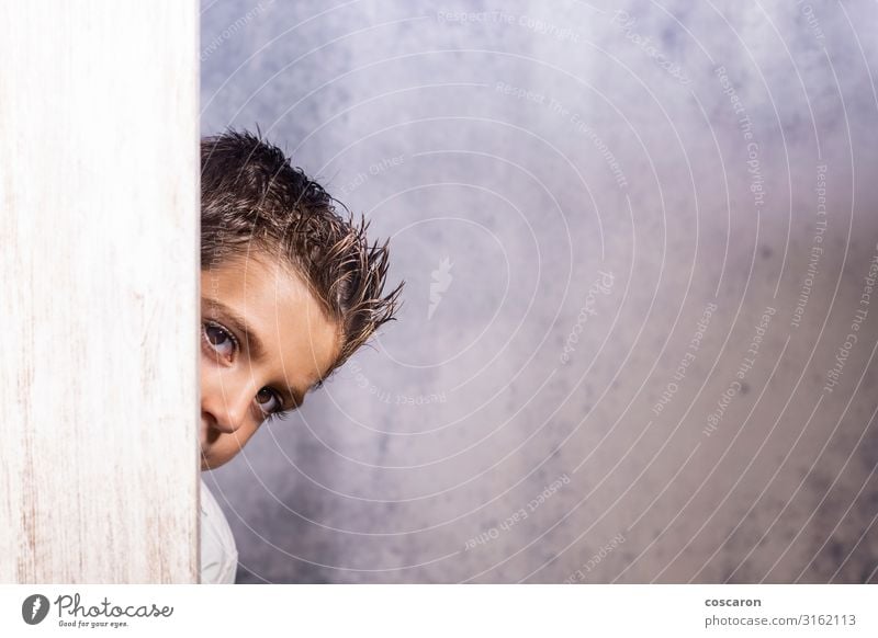 Little cute child hiding under a wooden door Joy Happy Beautiful Face Leisure and hobbies Children's game Schoolchild Human being Masculine Toddler Boy (child)