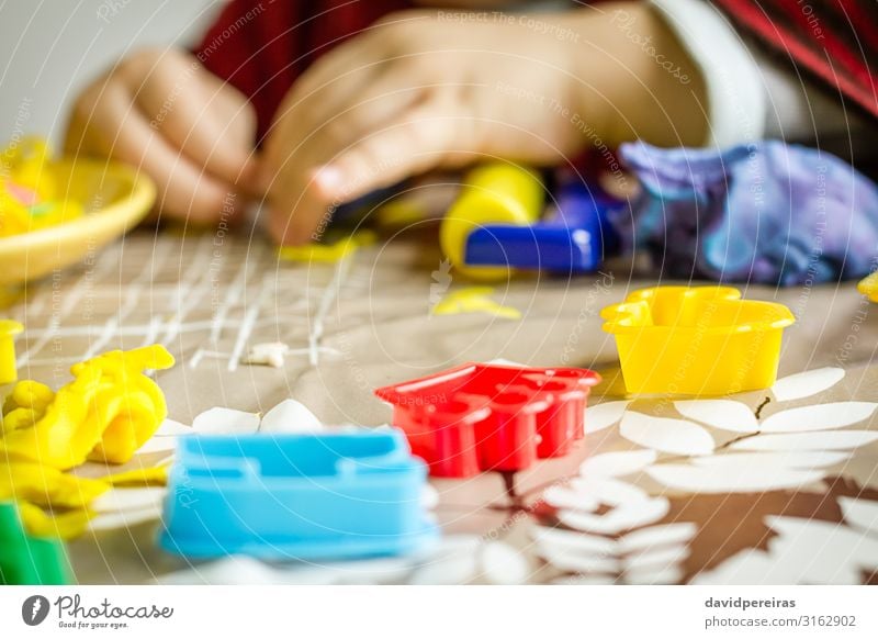 Closeup of plasticine molds and child hands on the background Dough Baked goods Joy Playing Table Child Boy (child) Infancy Toys Cute Creativity Action Clay